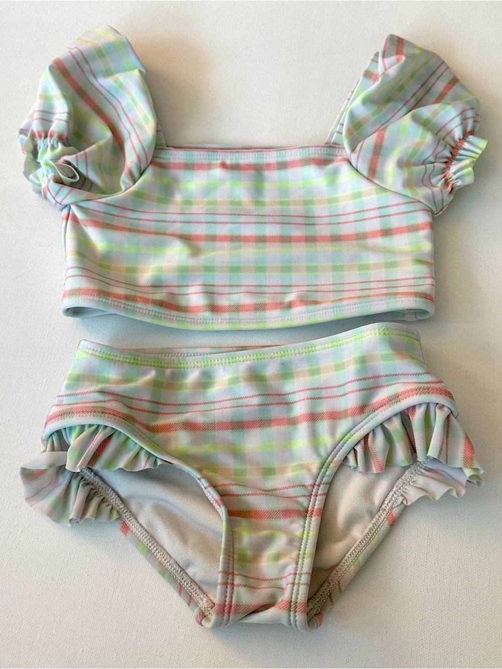 Cat & Jack girl’s two-piece swimsuit, puff sleeves and ruffled bottoms.  Size 4T